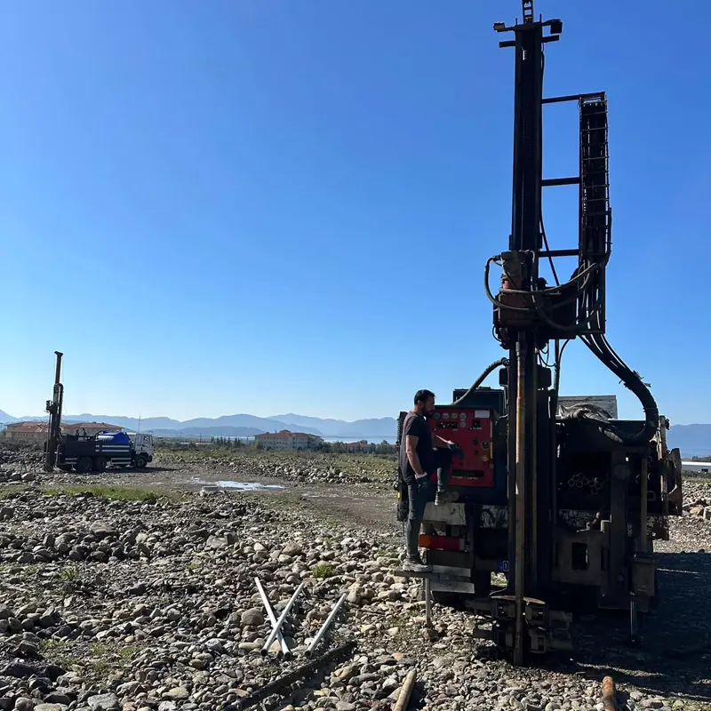 Operator working at a drilling rig in open terrain